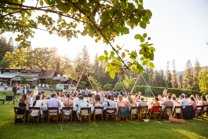 Wedding guests enjoy a formal outdoor dinner event on Gates Gables Lawn