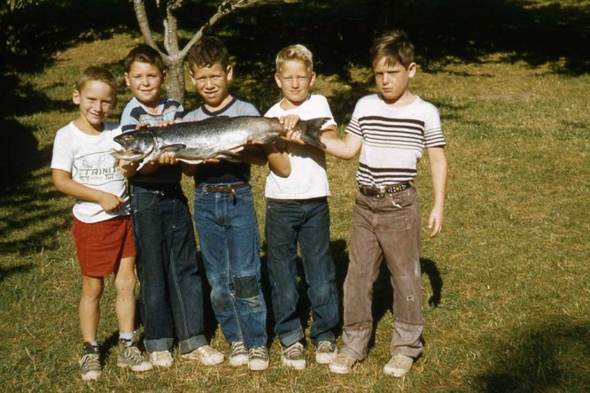 Five young campers show off a large fish that they caught