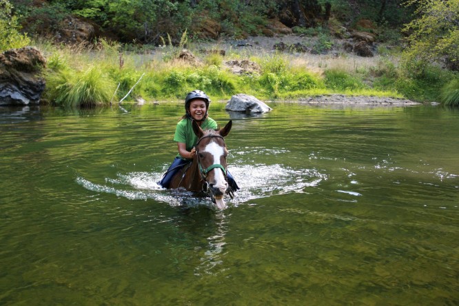 camper on horseback swimming across Hyampom Creek