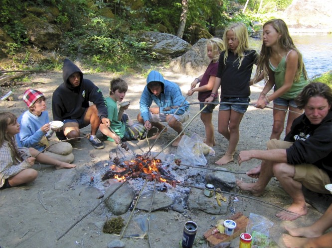 campers cooking over a campfire