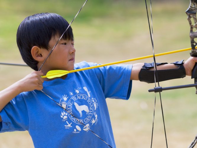 Camper prepares to shoot compound bow